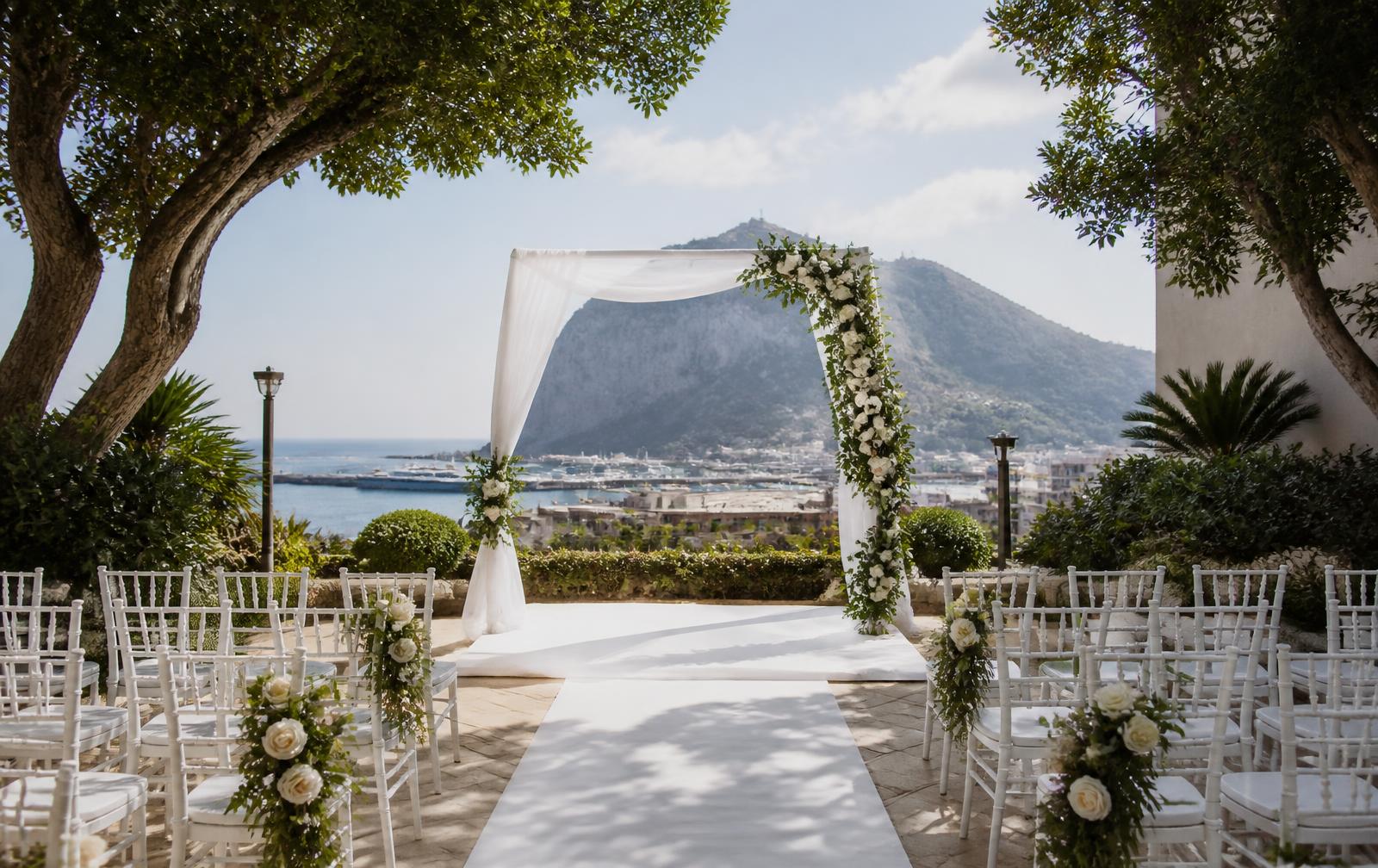 Outdoor wedding ceremony arch overlooking Gibraltar marina